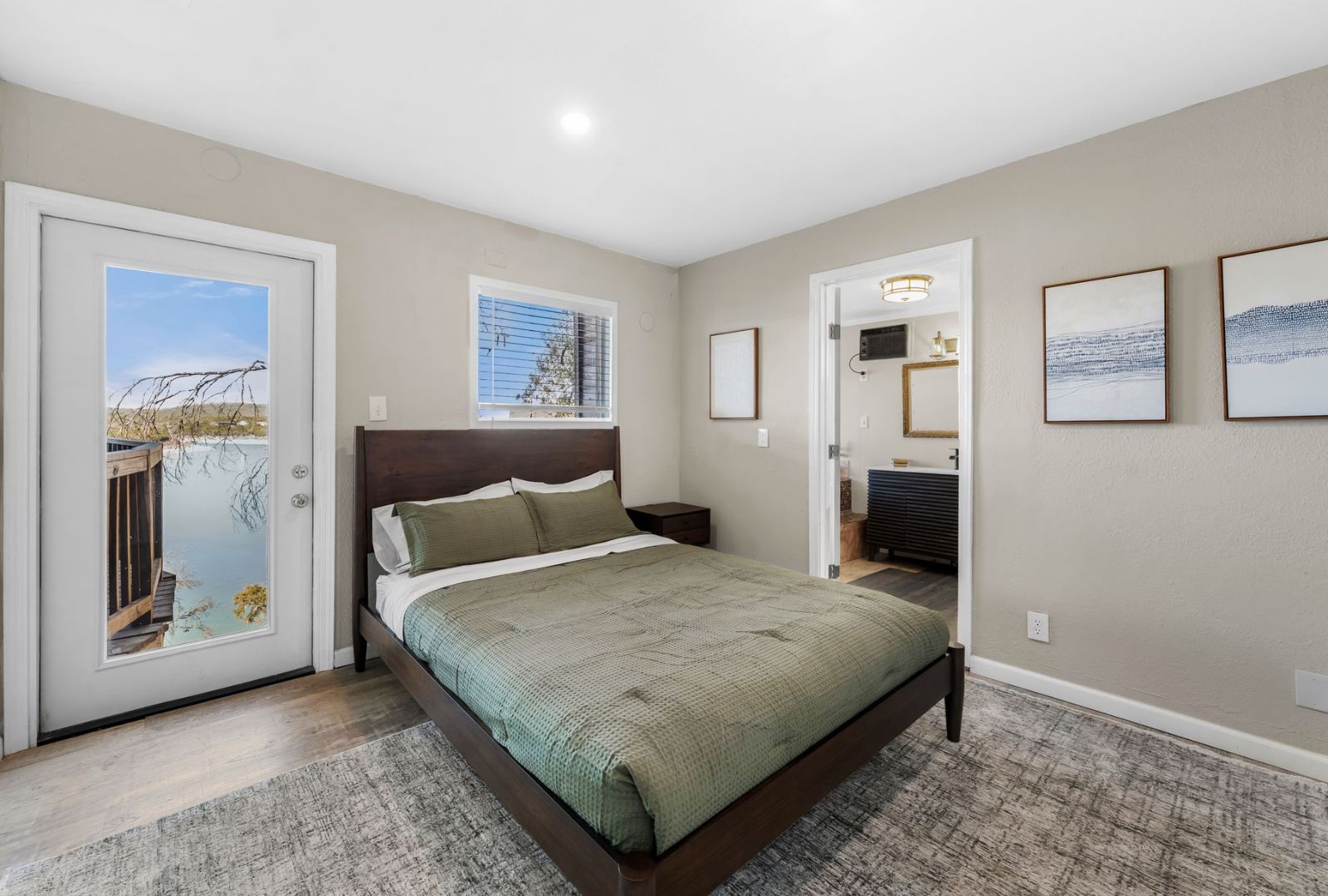 8124 Joy Road Volente, TX 78641 - Photo 12 of 31 a bedroom with a large bed and a painting