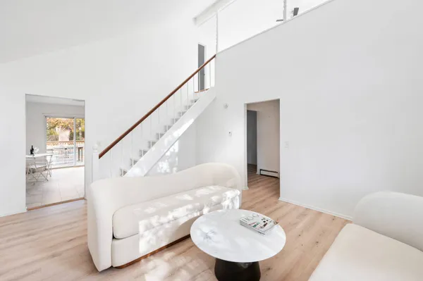 a living room with furniture and a dining table
