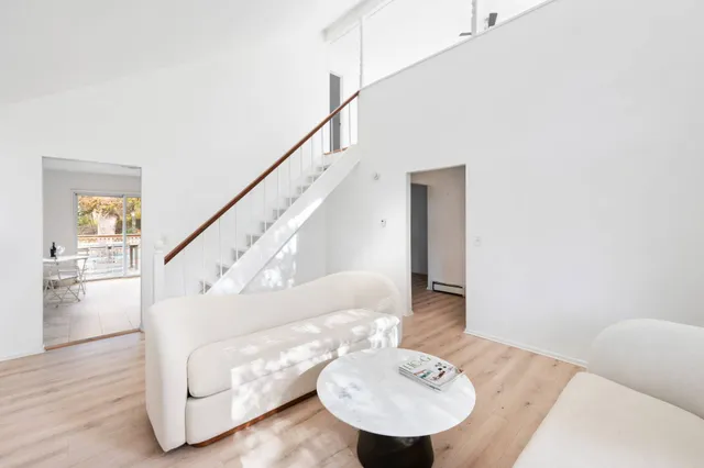 a living room with furniture and a dining table