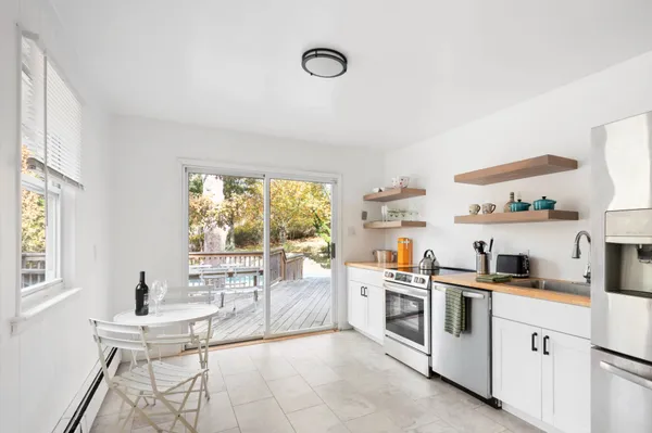 a kitchen with white cabinets and white appliances