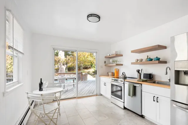 a kitchen with white cabinets and white appliances