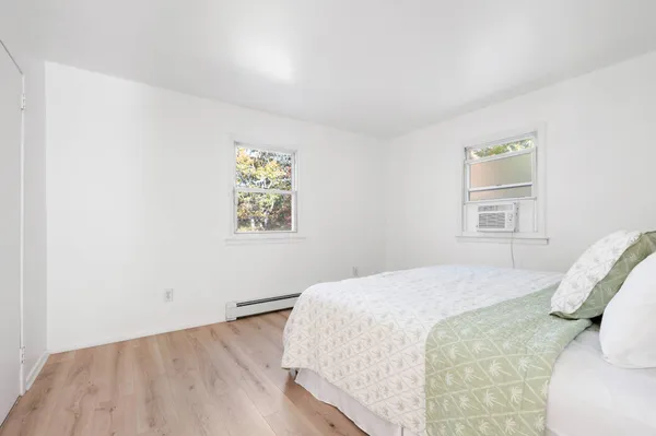 a bedroom with a bed and a window