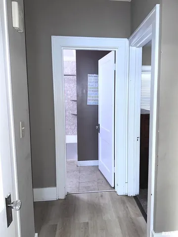 a view of a hallway with closet and cabinet