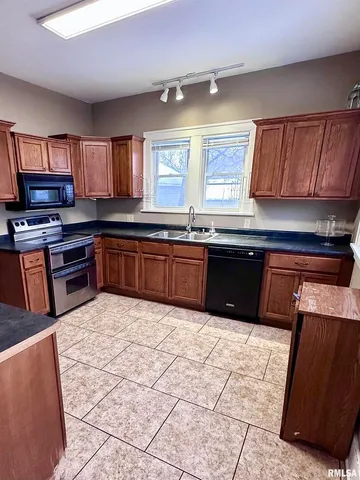 a kitchen with stainless steel appliances granite countertop a sink and cabinets