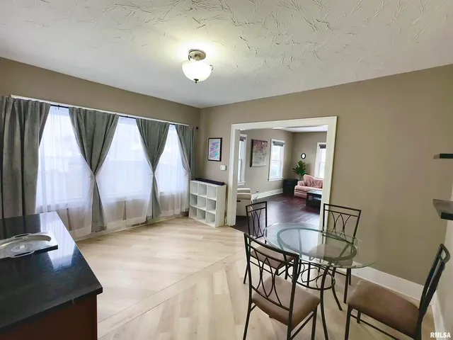 a dining room with furniture and a window