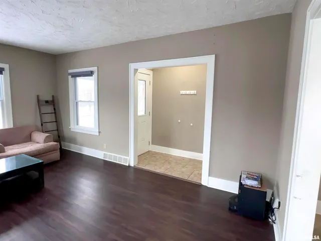 a view of room with furniture and wooden floor
