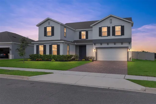 a front view of a house with a yard and garage