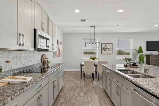 a kitchen with granite countertop lots of counter top space and stainless steel appliances
