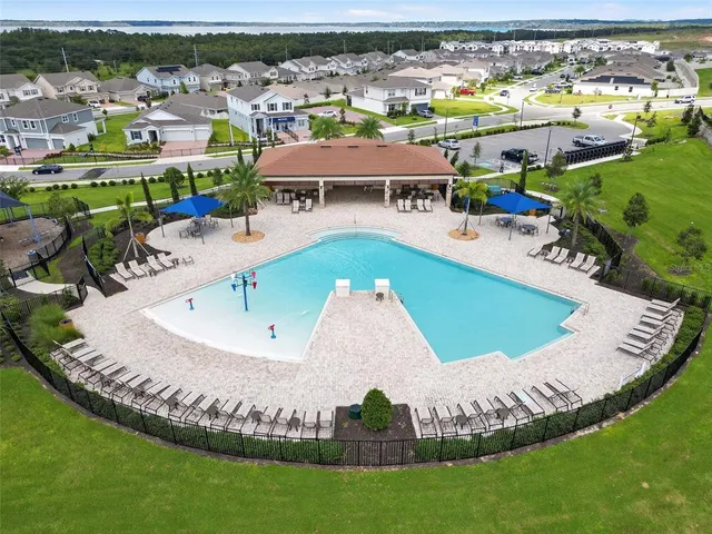 a view of a swimming pool with lawn chairs