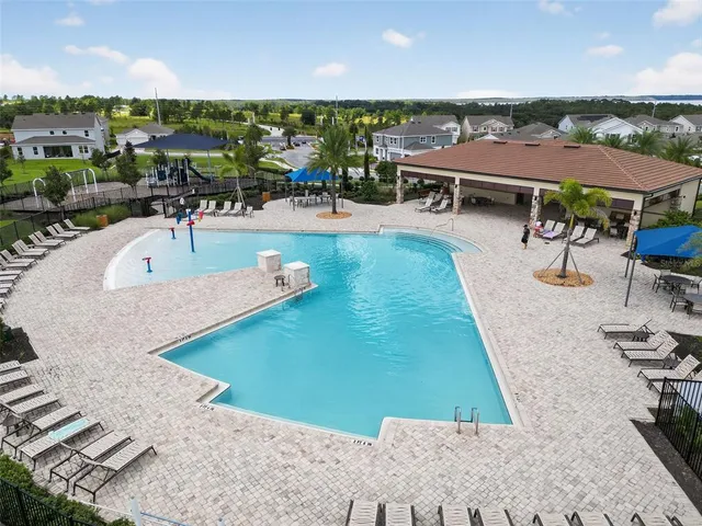 an aerial view of residential houses with outdoor space and swimming pool