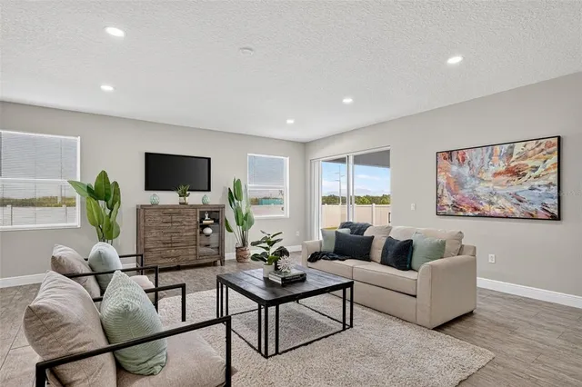 a large kitchen with stainless steel appliances a lot of counter space and a wooden floor