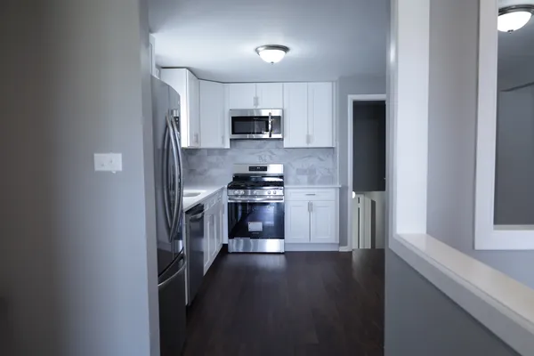 a kitchen with stainless steel appliances a refrigerator a stove a microwave and cabinets