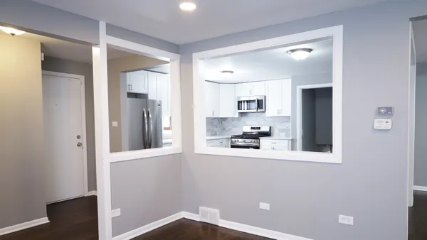 a view of a kitchen with a refrigerator and a stove