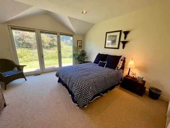 a bedroom with a bed and a large window