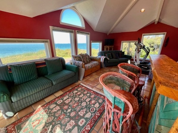 41 Naushon Road Aquinnah, MA 02535 - Photo 9 of 12 a living room with furniture and a floor to ceiling window
