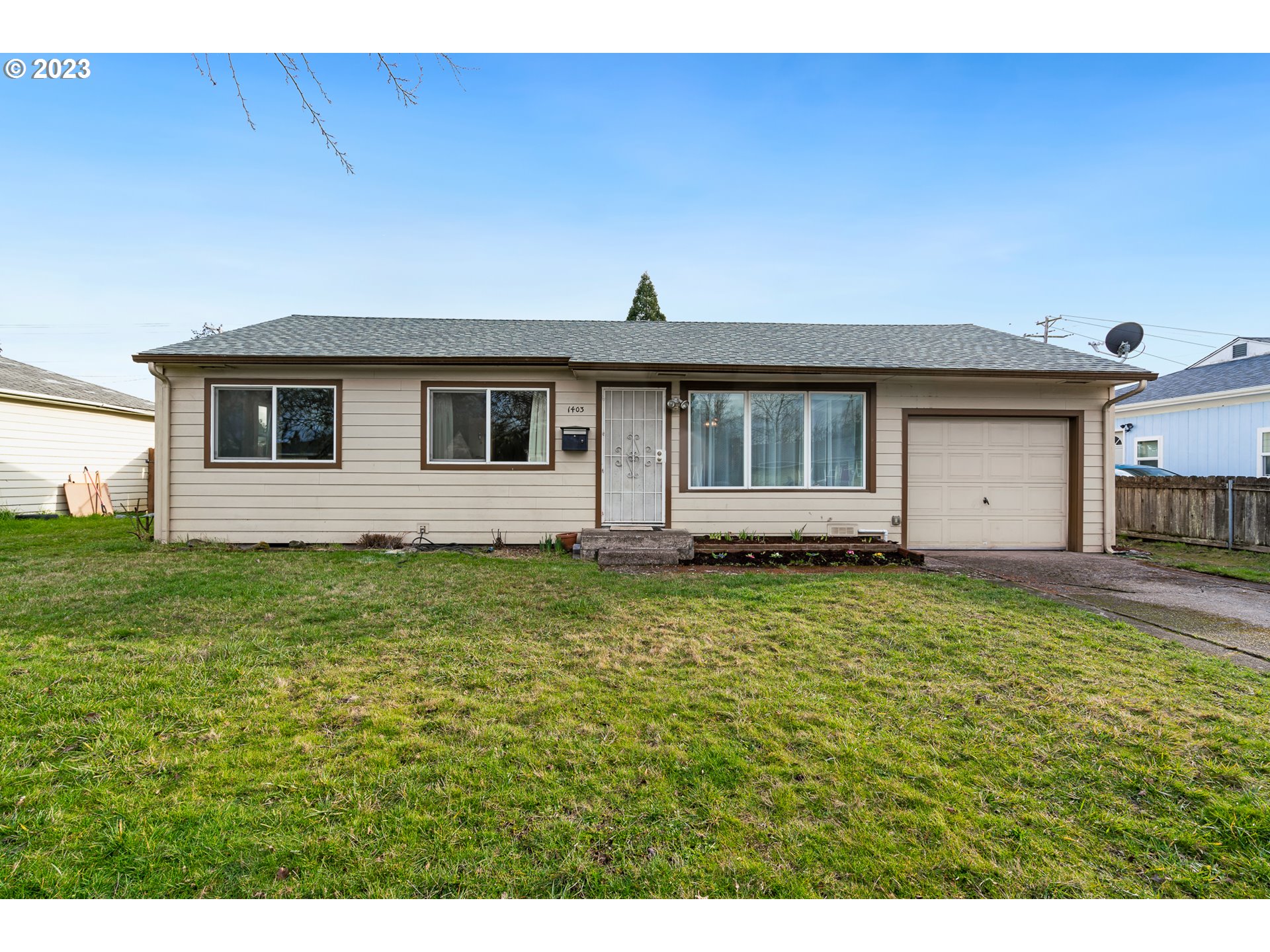 1403 L Street Springfield, OR 97477 - Photo 2 of 18 a view of a backyard with large trees