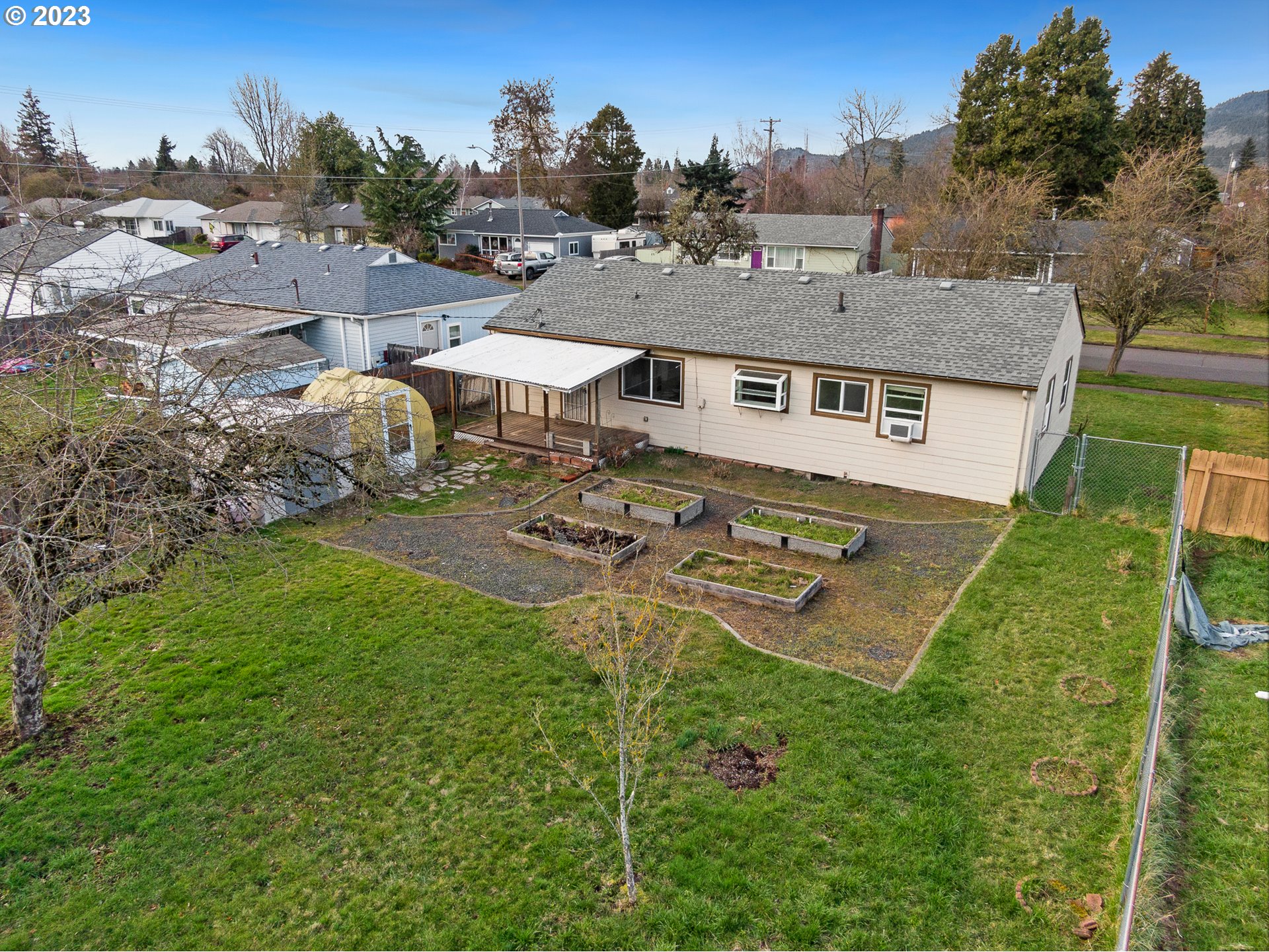 1403 L Street Springfield, OR 97477 - Photo 3 of 18 an aerial view of a house with garden space and street view