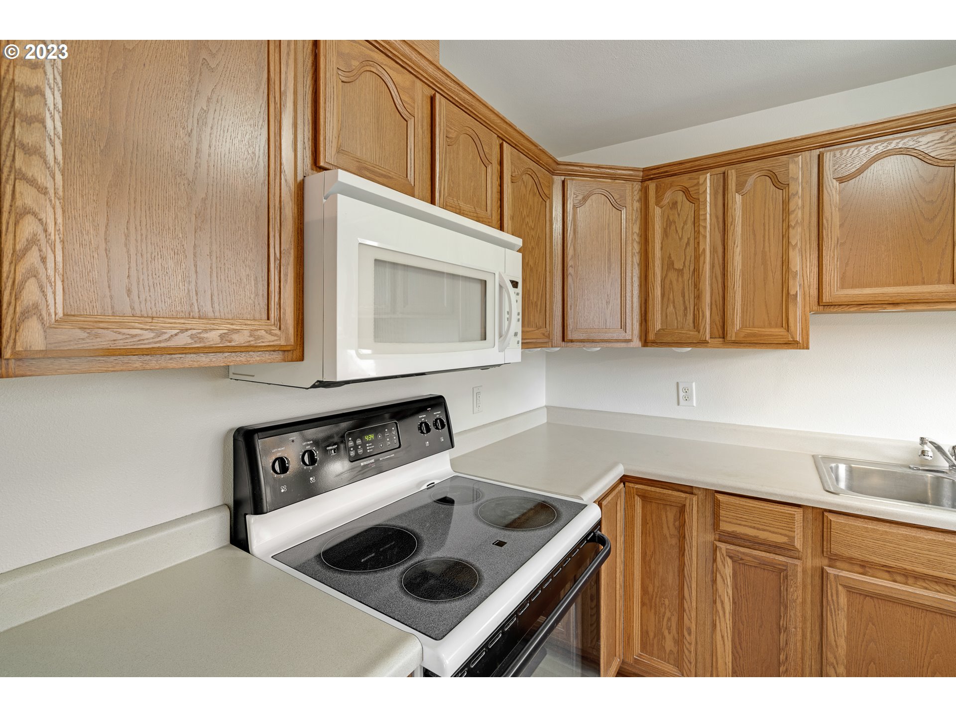1403 L Street Springfield, OR 97477 - Photo 7 of 18 a kitchen with a sink a stove and cabinets