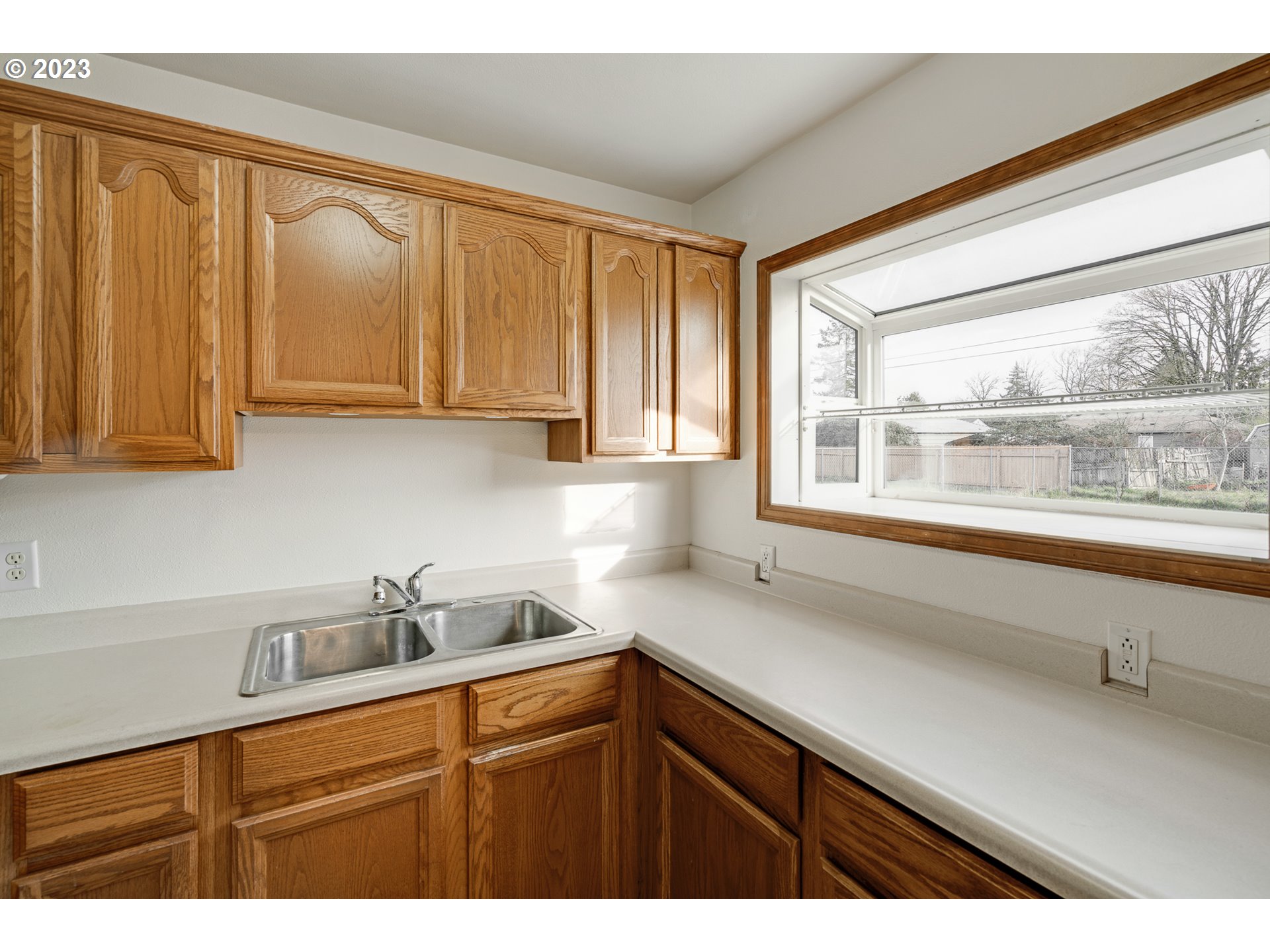 1403 L Street Springfield, OR 97477 - Photo 8 of 18 a kitchen with stainless steel appliances white cabinets and a sink