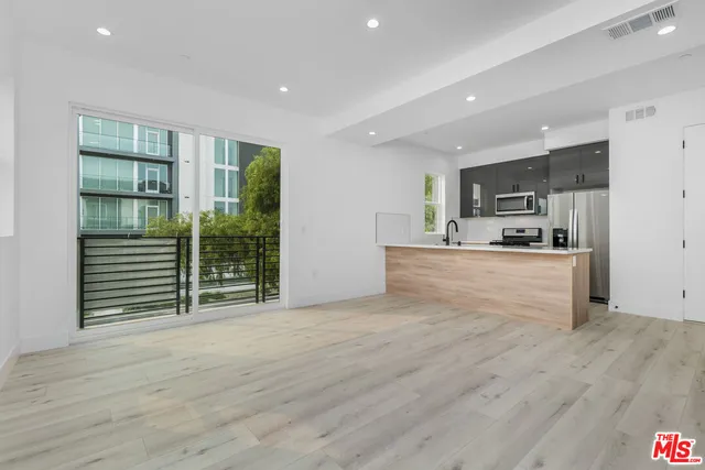 a kitchen with stainless steel appliances a refrigerator and a sink
