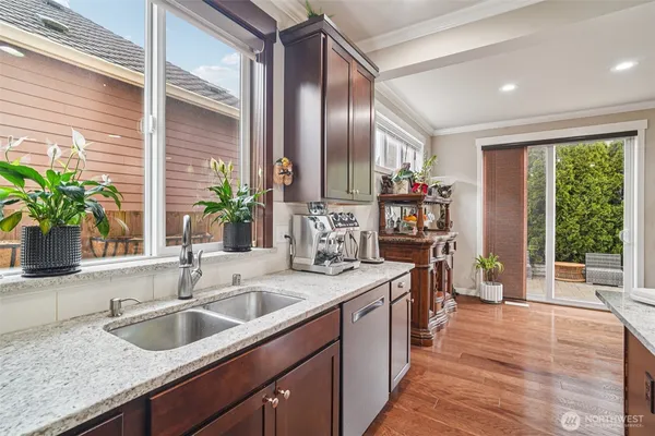 a kitchen with sink and large window