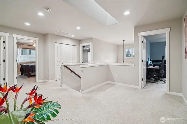 a bedroom with a bed a dresser and next to a window