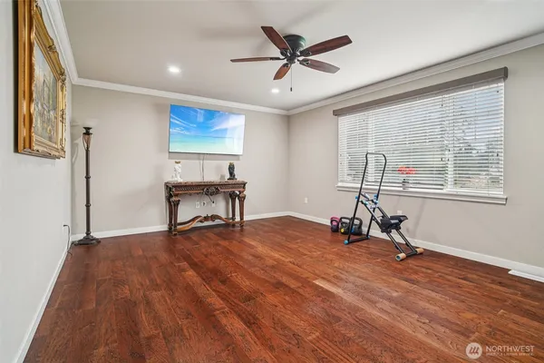 a view of a livingroom with hardwood floor and a ceiling fan