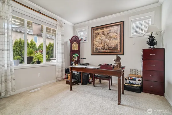 a view of a workspace with a window and furniture