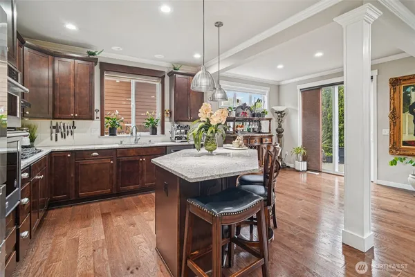 a kitchen with a table chairs sink and cabinets