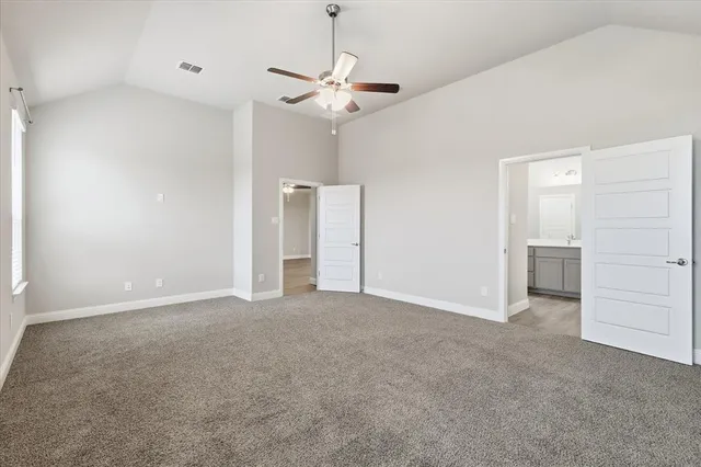 a view of an empty room with a ceiling fan