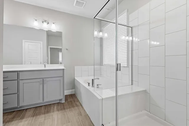 a bathroom with a double vanity sink a mirror and shower