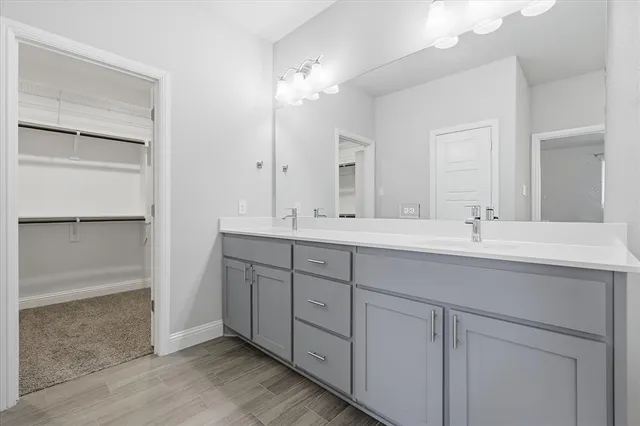 a bathroom with double vanity sink and a mirror