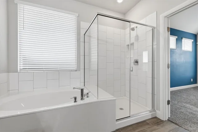 a bathroom with a bathtub and a shower