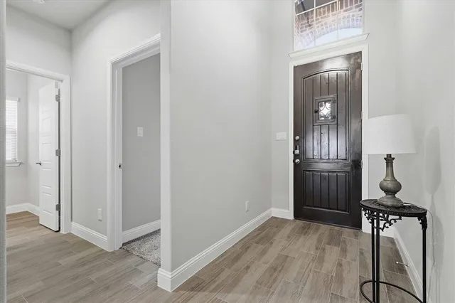 a view of a hallway with wooden floor