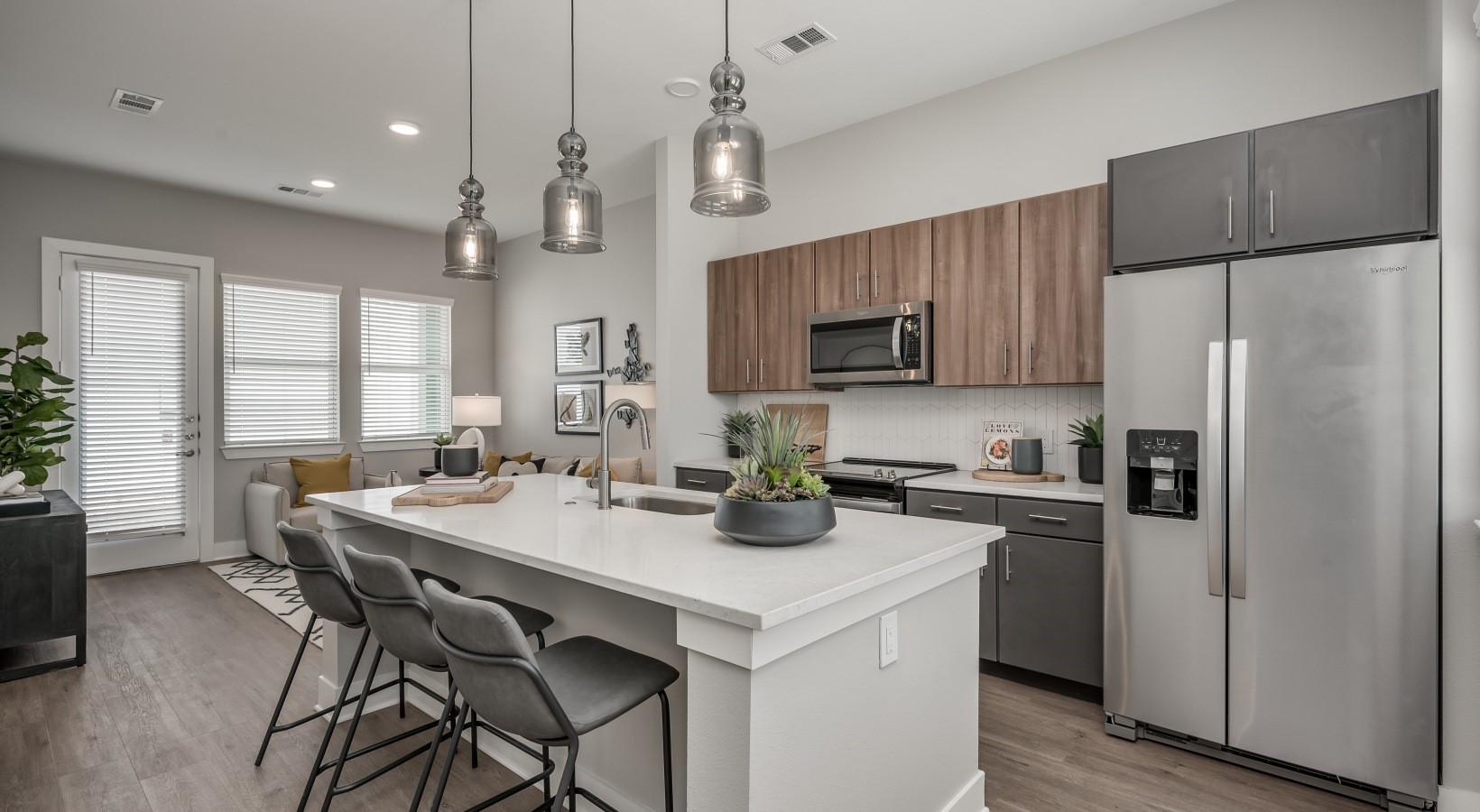 10503 Peek Road, Unit 1206 Cypress, TX 77433 - Photo 2 of 10 a kitchen with refrigerator a stove a center island a dining table and chairs