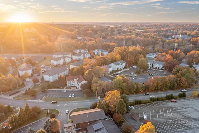 a view of an empty room with a window and fireplace