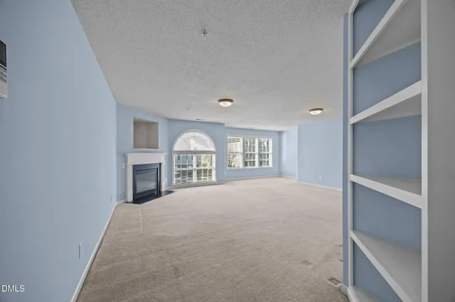 a view of an empty room with a ceiling fan