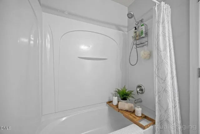 a view of an empty room and chandelier fan