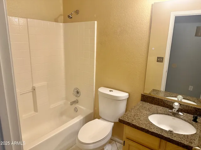 a bedroom with a bed and painting on the wall