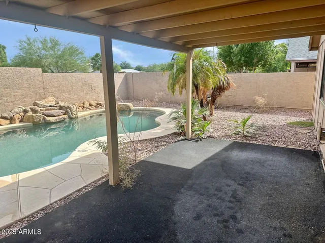 a view of a backyard with swimming pool