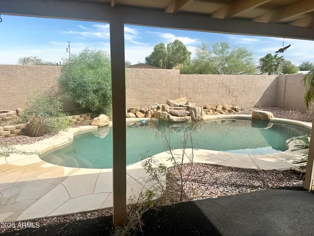 a view of a swimming pool with outdoor seating
