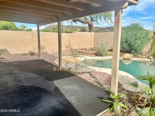 a view of a swimming pool with a yard