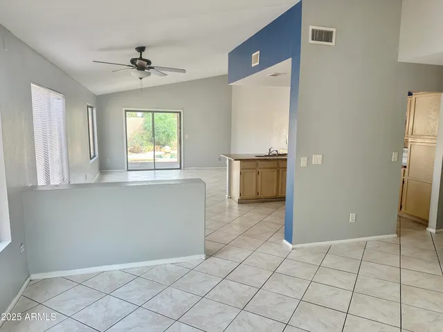 a view of an empty room with window and cabinet