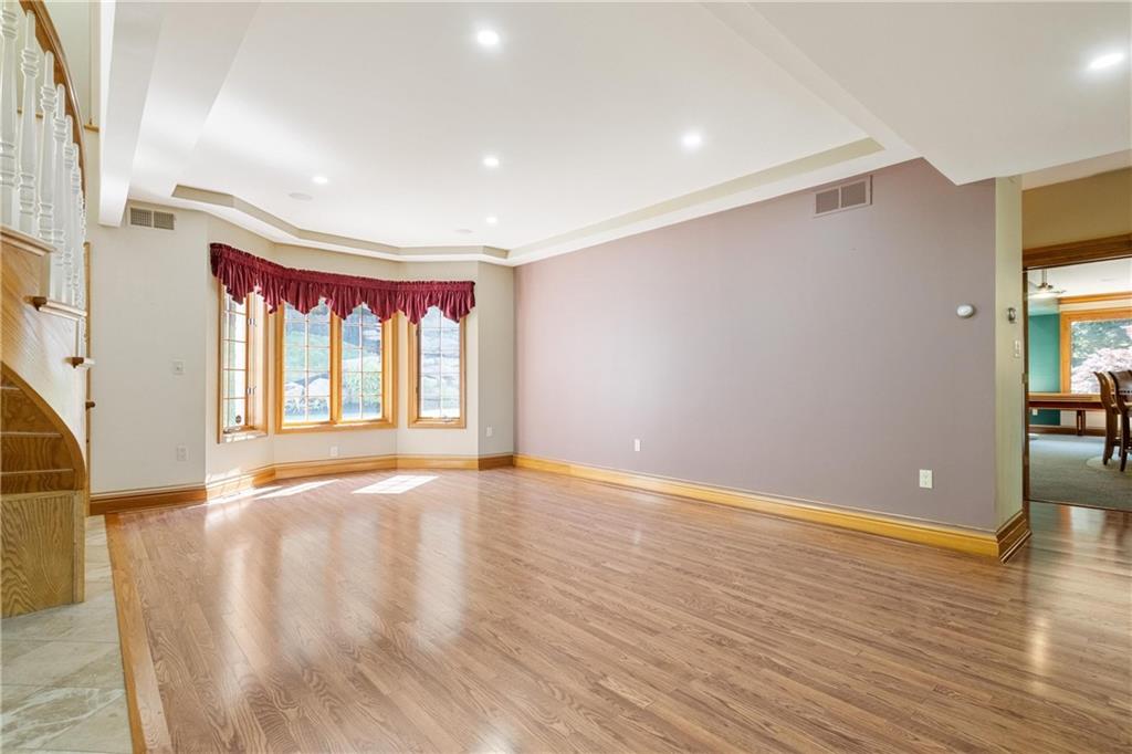 179 Goldsmith Road Pittsburgh, PA 15237 - Photo 7 of 50 a view of an empty room with wooden floor and a window