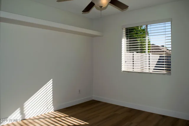 a view of room with window and ceiling fan