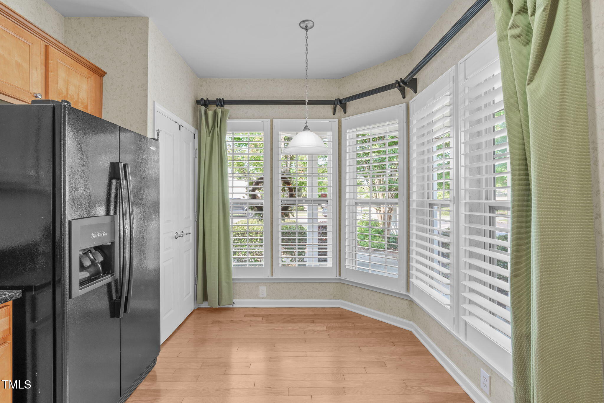 128 Arvind Oaks Circle Cary, NC 27519 - Photo 10 of 34 a view of a hallway with windows and refrigerator