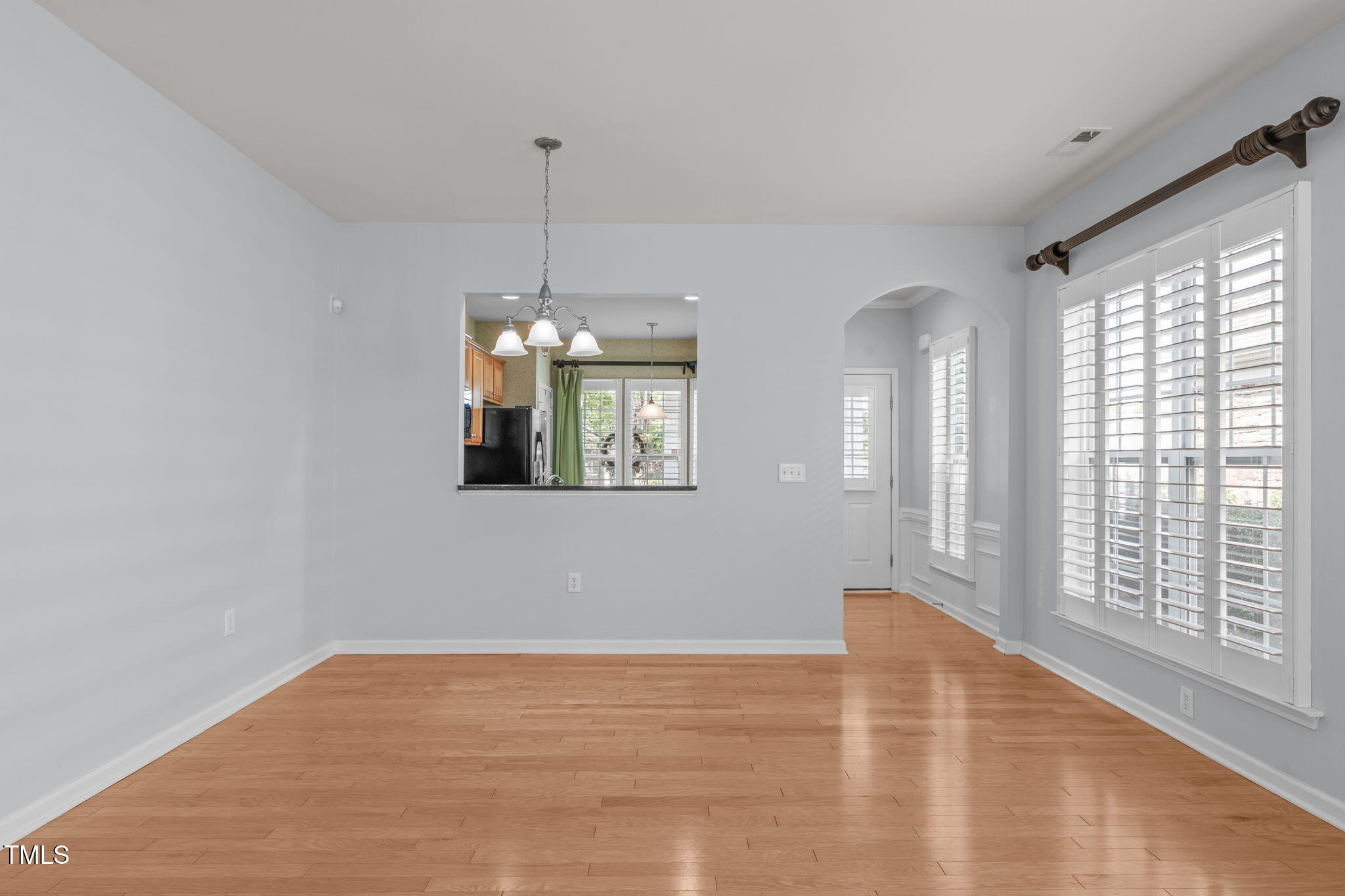 128 Arvind Oaks Circle Cary, NC 27519 - Photo 12 of 34 a view of an empty room with wooden floor and a window