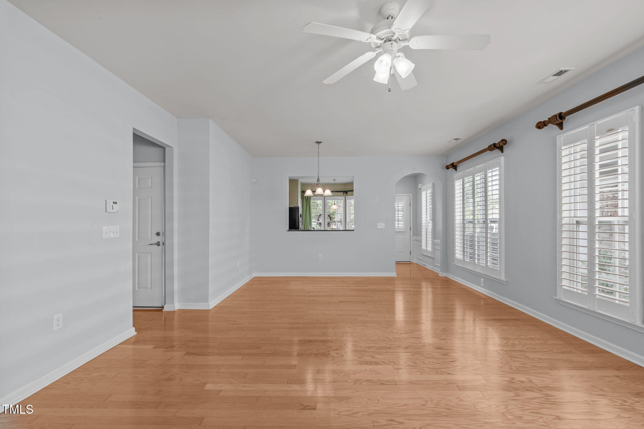 128 Arvind Oaks Circle Cary, NC 27519 - Photo 15 of 34 a view of an empty room with window and chandelier fan