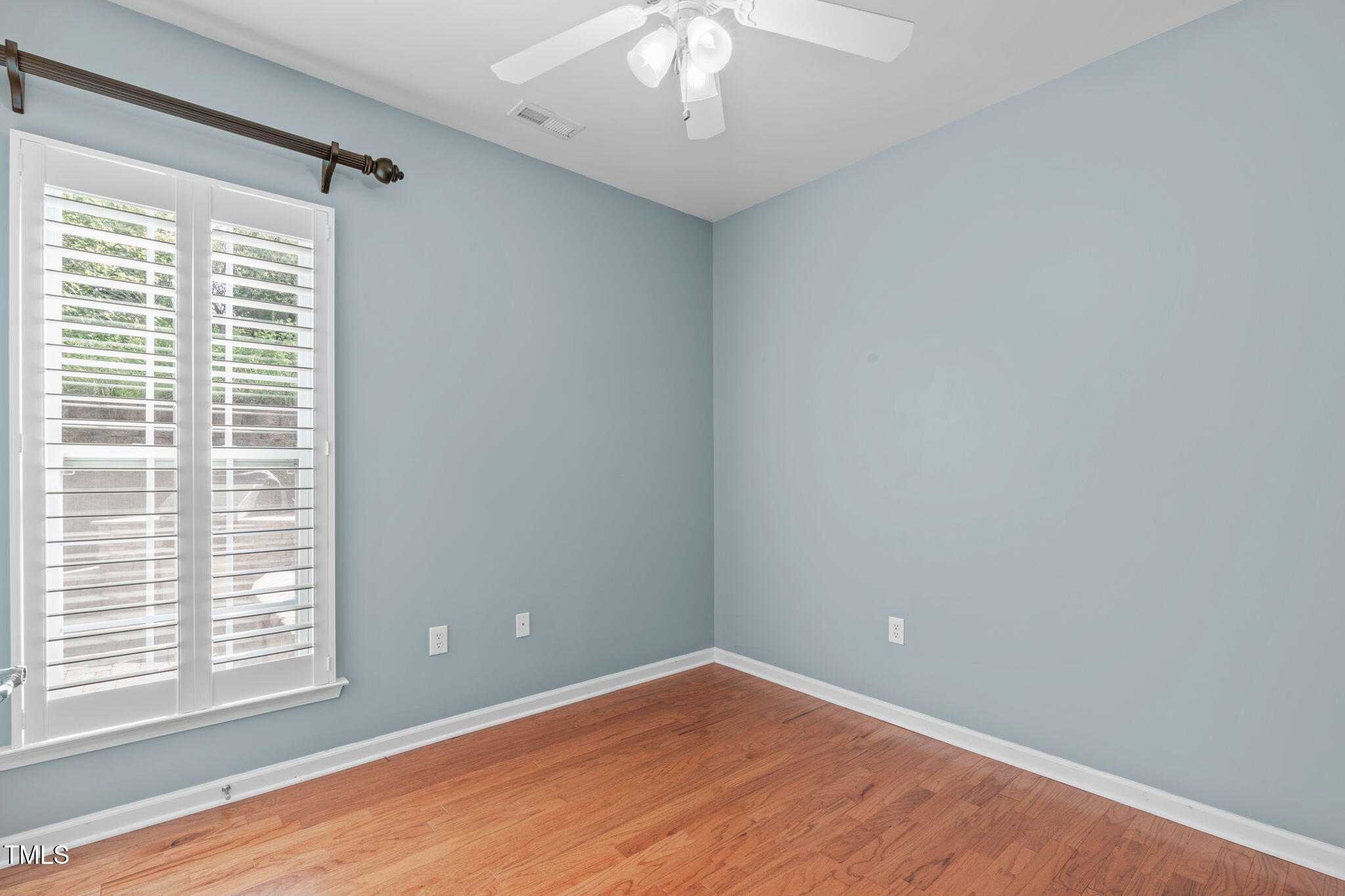 128 Arvind Oaks Circle Cary, NC 27519 - Photo 18 of 34 an empty room with wooden floor and windows