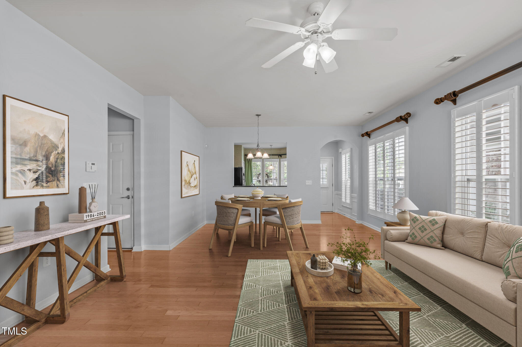 128 Arvind Oaks Circle Cary, NC 27519 - Photo 2 of 34 a living room with furniture a dining table and a chandelier